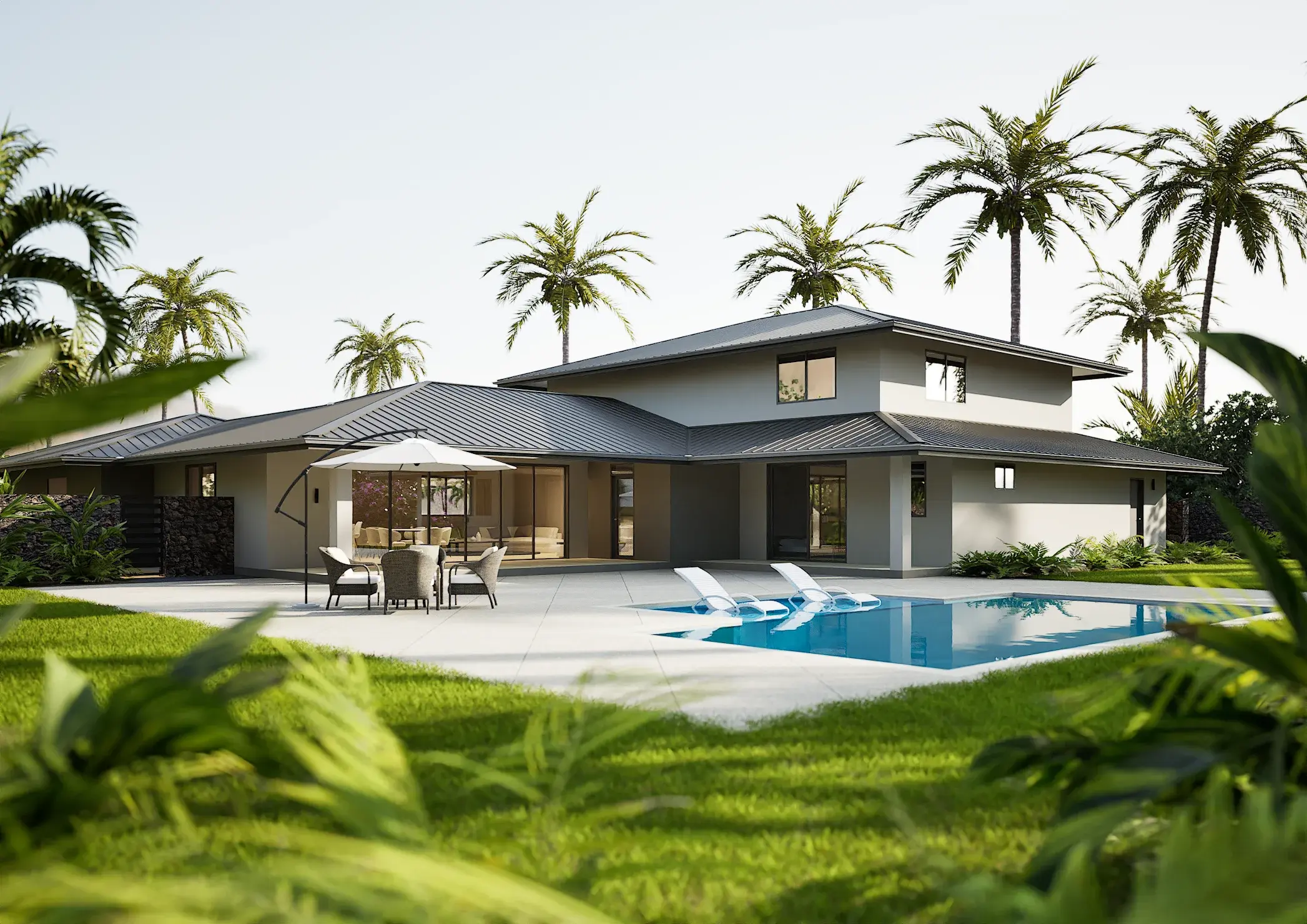 Poolside view of the modern tropical villa framed by palms and dense planting